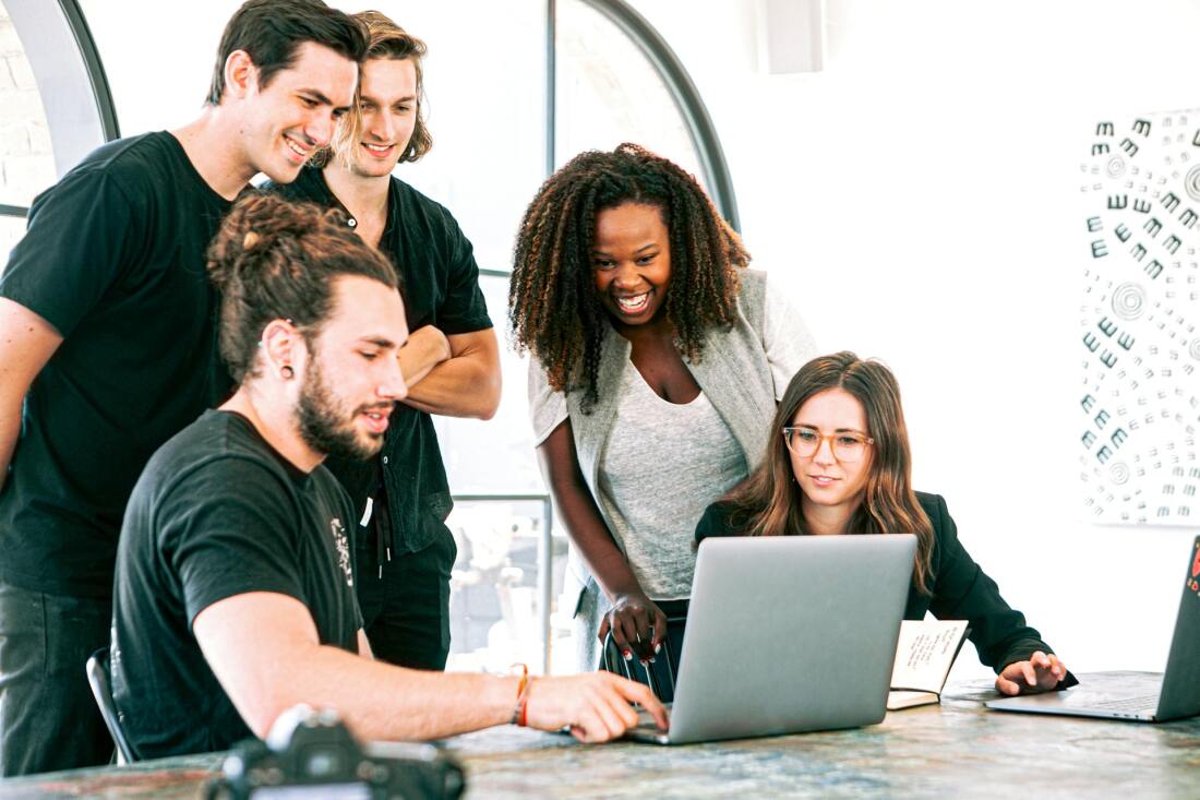 People looking at one laptop